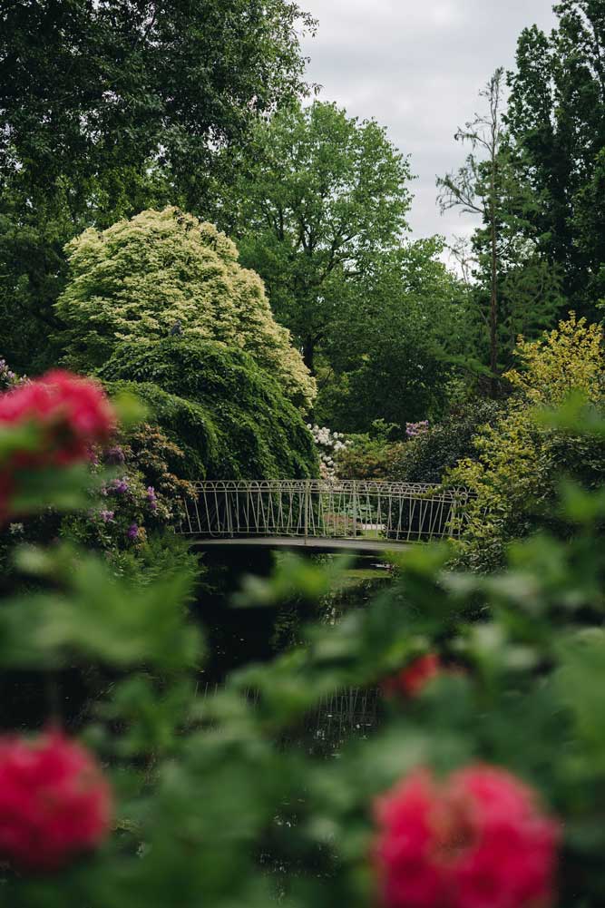 Doorkijk-naar-een-bruggetje-in-bloeiende-tuin